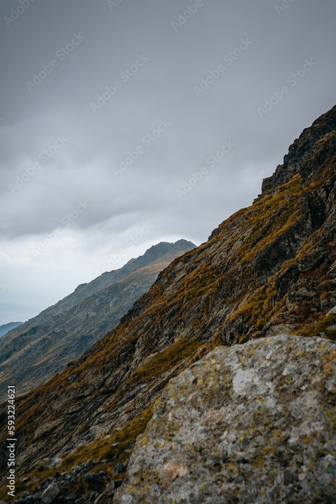 Vertical shot of the mountainous landscape under a cloudy sky