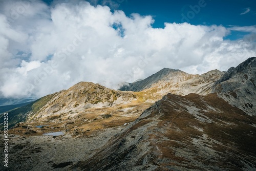 Beautiful landscape of big mountains with rocky peaks under the cloudy sky