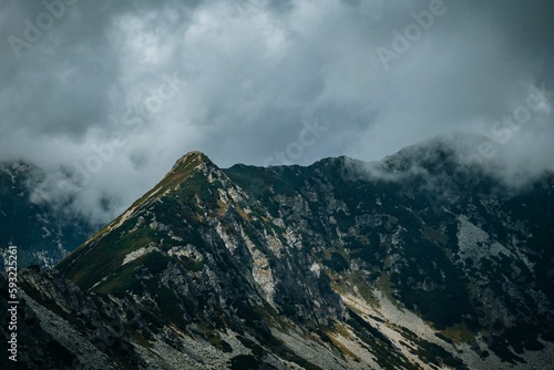 Beautiful landscape of big mountains with rocky peaks under the cloudy sky