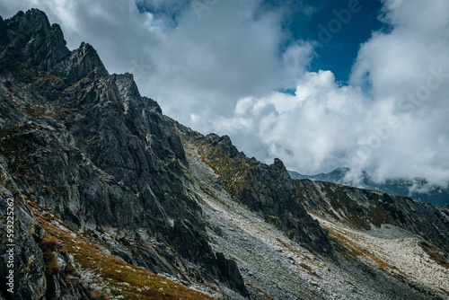 Beautiful landscape of big mountains with rocky peaks under the cloudy sky