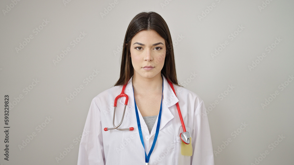 Young beautiful hispanic woman doctor standing with relaxed expression over isolated white background Young beautiful hispanic woman doctor standing with relaxed expression over isolated white background