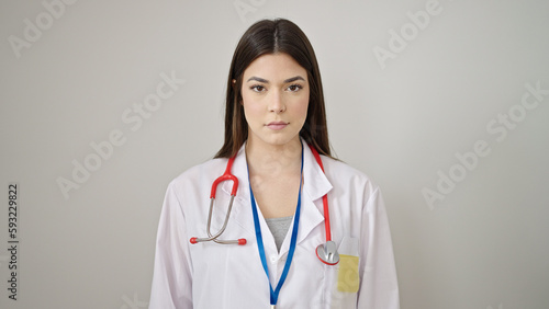 Young beautiful hispanic woman doctor standing with relaxed expression over isolated white background