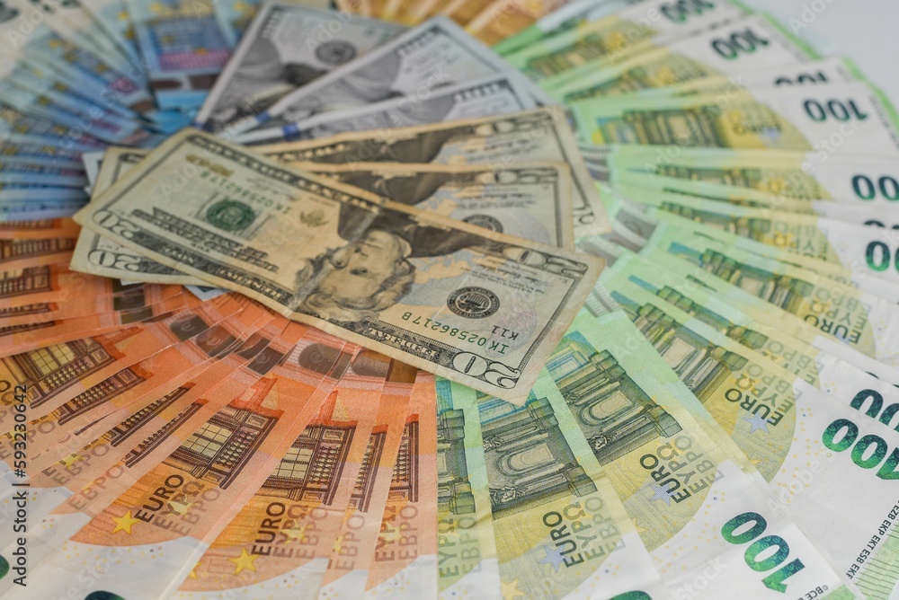 Closeup shot of Euro and USD banknotes stacked in order Closeup shot of Euro and USD banknotes stacked in order