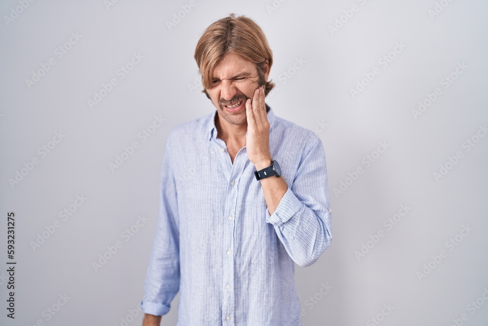 Caucasian man with mustache standing over white background touching mouth with hand with painful expression because of toothache or dental illness on teeth. dentist Caucasian man with mustache standing over white background touching mouth with hand with painful expression because of toothache or dental illness on teeth. dentist