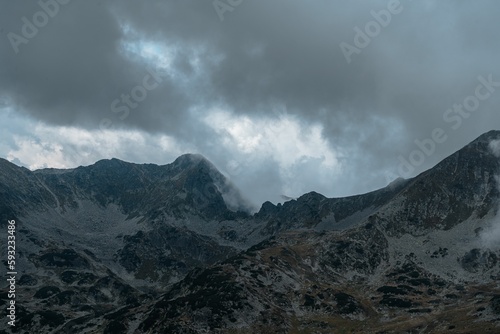 Rocky mountains covered with grass in summer on a cloudy day