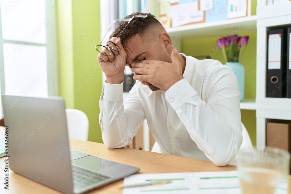Young hispanic man business worker stressed using laptop at office Young hispanic man business worker stressed using laptop at office