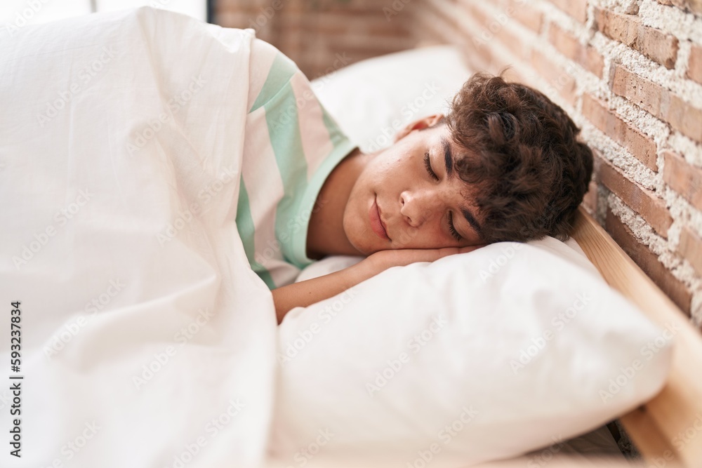 Young hispanic teenager lying on bed sleeping at bedroom Young hispanic teenager lying on bed sleeping at bedroom