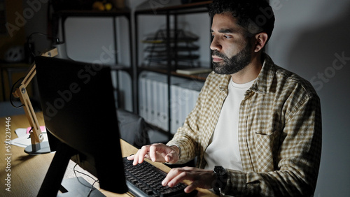 Young hispanic man business worker using computer working at office