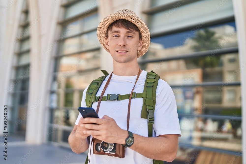 Young caucasian man tourist smiling confident using smartphone at street Young caucasian man tourist smiling confident using smartphone at street