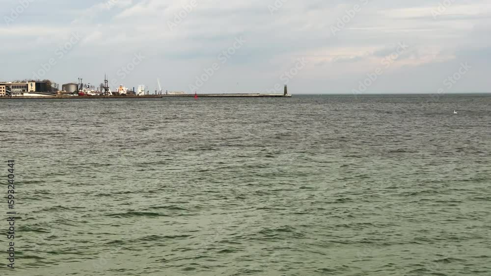 Cloudy day by the sea. Calm sea on a cloudy spring morning. Cloudy day by the sea. Calm sea on a cloudy spring morning.