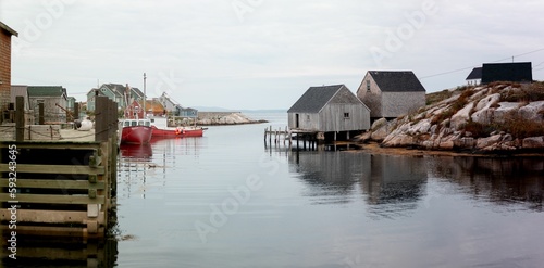 Group of small houses on a river, Peggy's Cove, Nova Scotia, Canada © Josh Bourget/Wirestock Creators