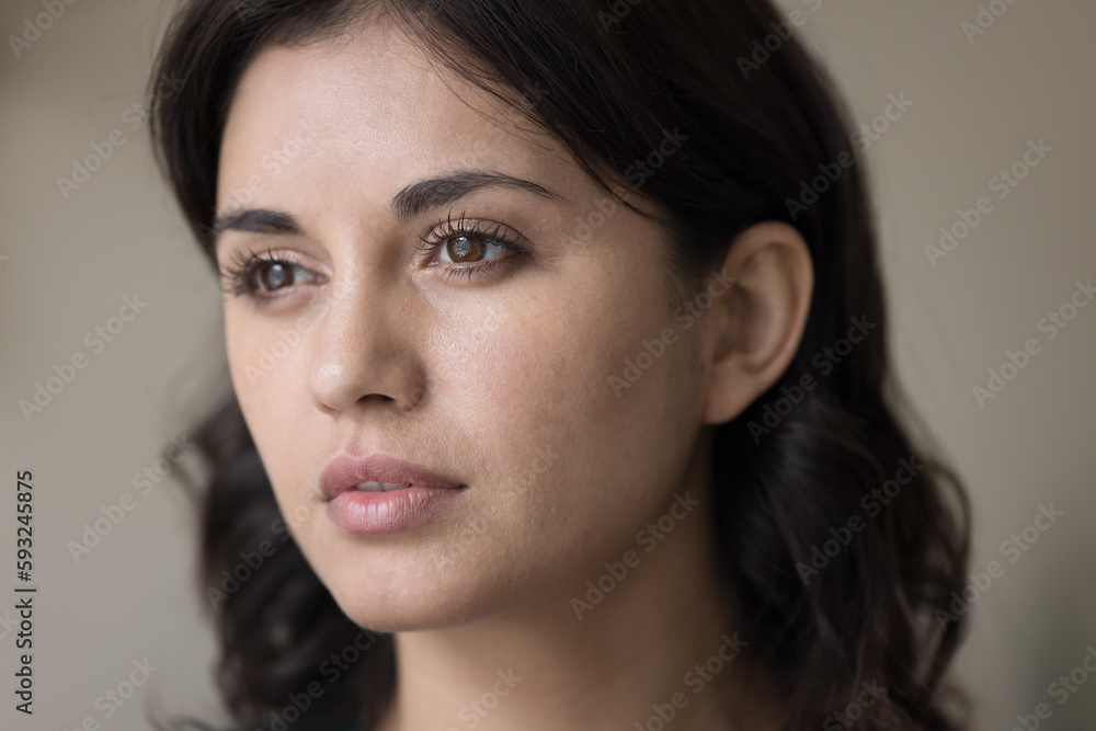 Close up young serious brunette Armenian woman staring into distance, think, looks deep in thoughts. Face of mindful thoughtful brown-eyed female, millennial generation person portrait, natural beauty Close up young serious brunette Armenian woman staring into distance, think, looks deep in thoughts. Face of mindful thoughtful brown-eyed female, millennial generation person portrait, natural beauty