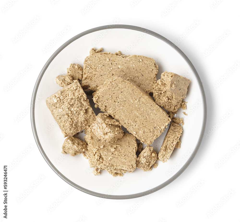 Plate with pieces of sweet halva on white background Plate with pieces of sweet halva on white background