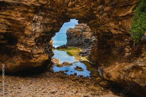 Grotto geological formation like an arch over the water in the daytime in Peterborough, Australia