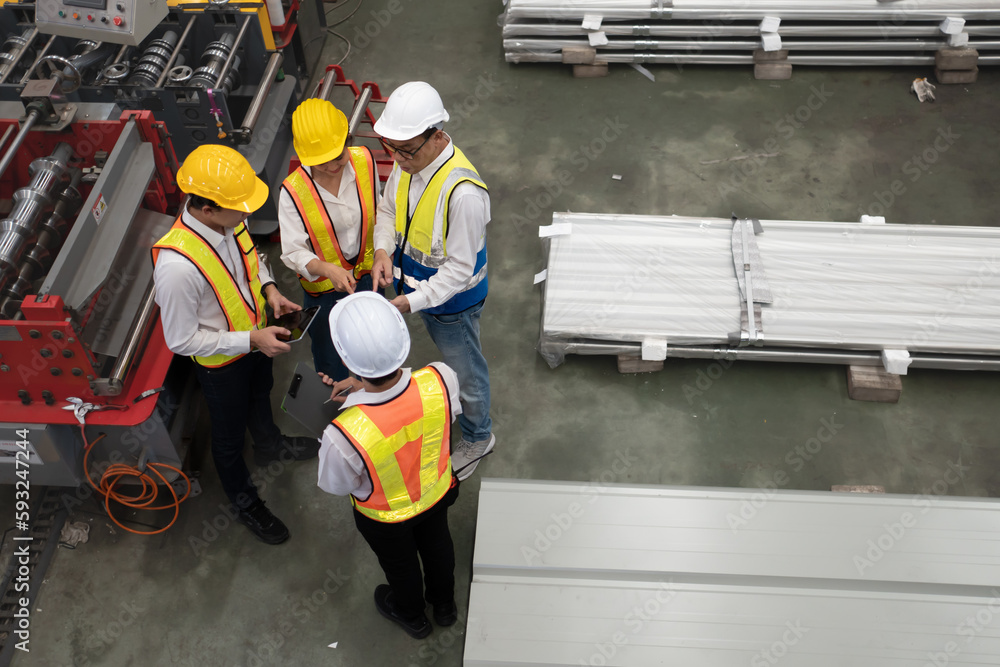 Top view of industrial engineer and factory workers wear safety helmets