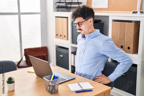 Young caucasian man business worker suffering for backache working at office