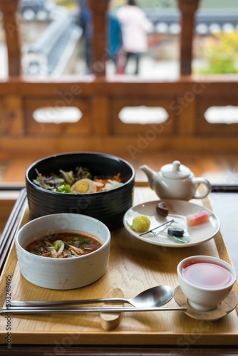 High-angle shot of a traditional Korean breakfast in a wooden setting.