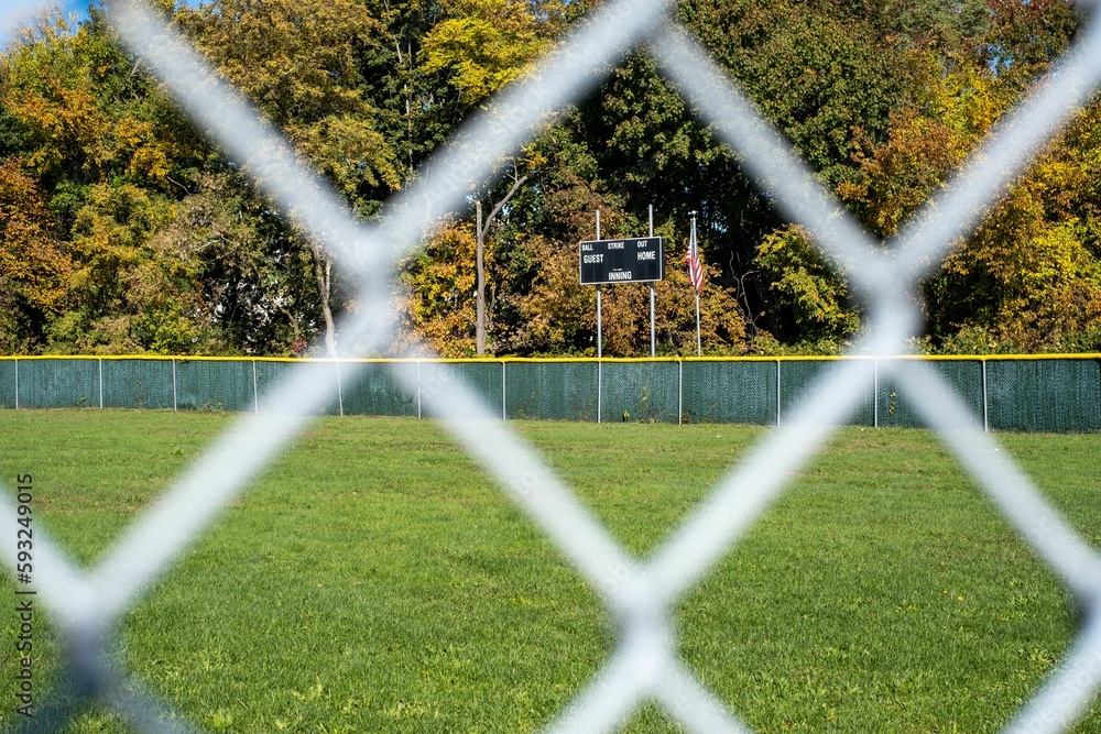 Natural view of a baseball field with blurry metal fence foreground Natural view of a baseball field with blurry metal fence foreground