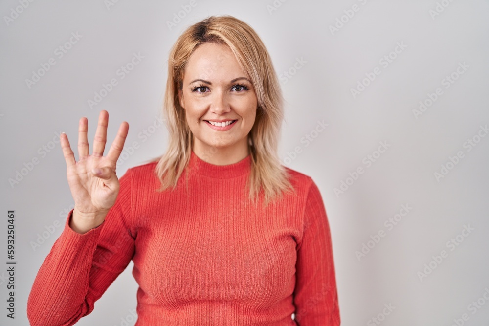 Blonde woman standing over isolated background showing and pointing up with fingers number four while smiling confident and happy. Blonde woman standing over isolated background showing and pointing up with fingers number four while smiling confident and happy.