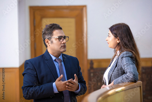 indian businessman discussing with female manager at office.