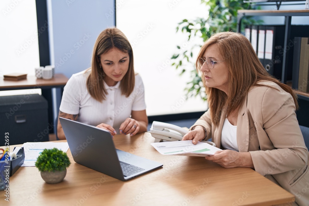 Mother and daughter business workers working at office Mother and daughter business workers working at office