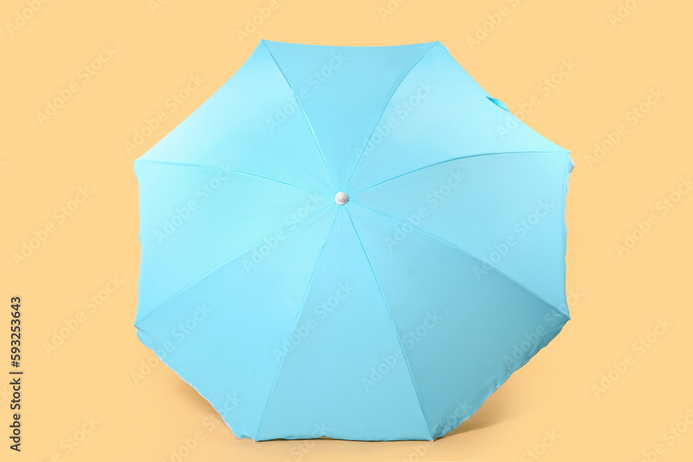 Blue beach umbrella on beige background Blue beach umbrella on beige background