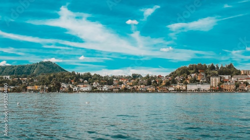 Fototapeta Naklejka Na Ścianę i Meble -  Calm waters of lake Traunsee with the old Gmunden town in the background in Austria on a sunny day