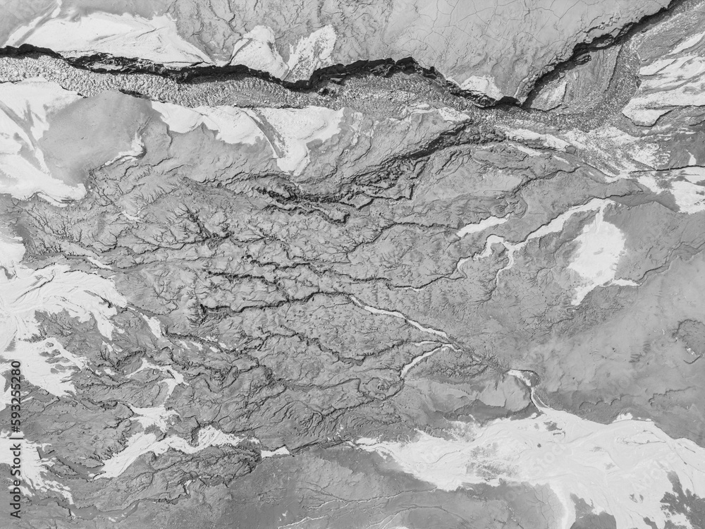 The structure of cracked wet earth at the bottom of the lake, creating irregular patterns, structure, background. Amazing shapes created by nature at the bottom of a lake where there is no water