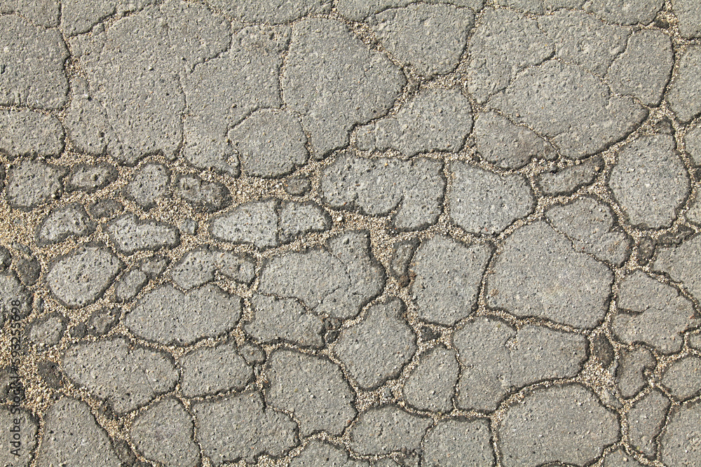 Textured backdrop. Mosaic texture, background of an old, cracked road. An old asphalt surface, background. Detailed texture of the bitumen close-up. Screen short. Road foundation Textured backdrop. Mosaic texture, background of an old, cracked road. An old asphalt surface, background. Detailed texture of the bitumen close-up. Screen short. Road foundation