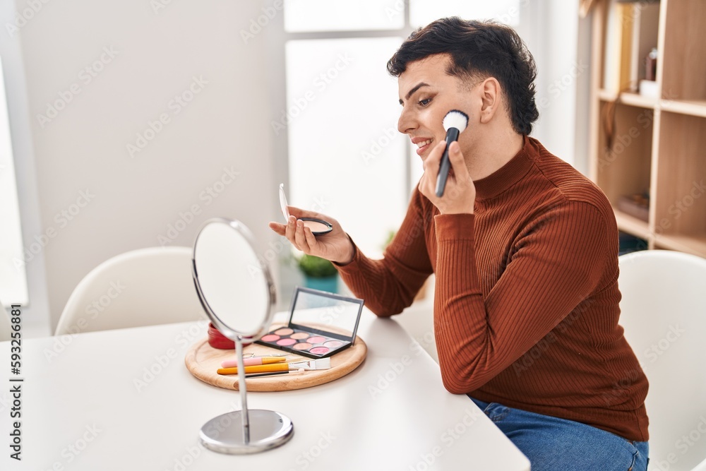 Young non binary man smiling confident applying makeup at home Young non binary man smiling confident applying makeup at home