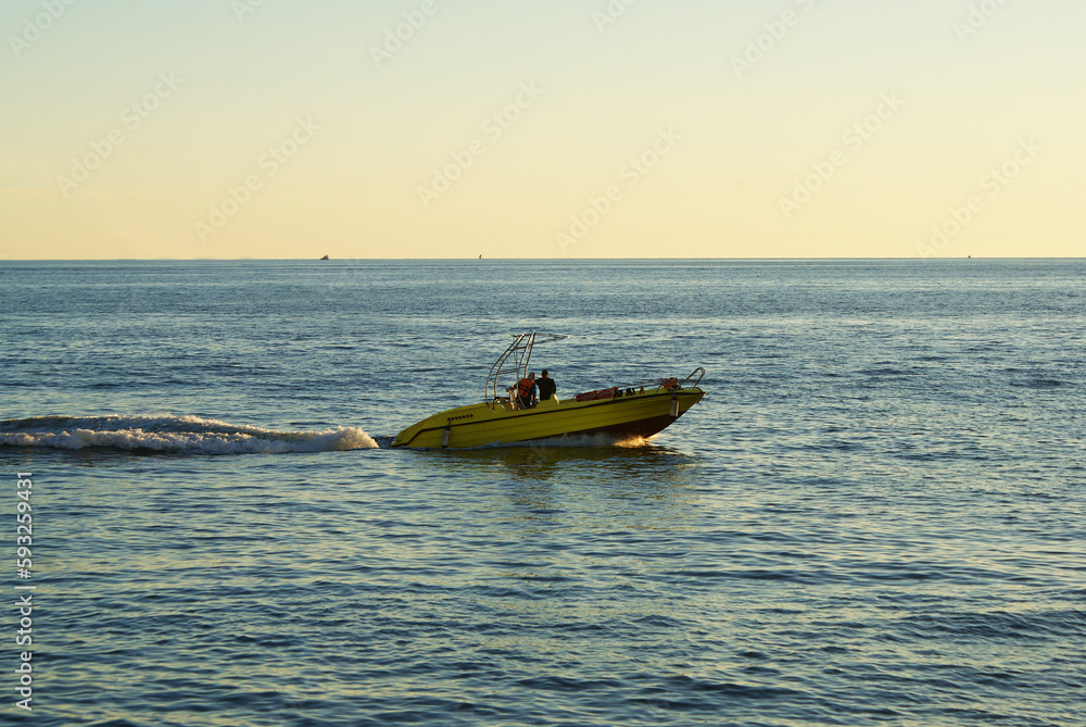 Yachts at sea on the background of sunset, sun glare, travel. Sailing. Yachts at sea on the background of sunset, sun glare, travel. Sailing.
