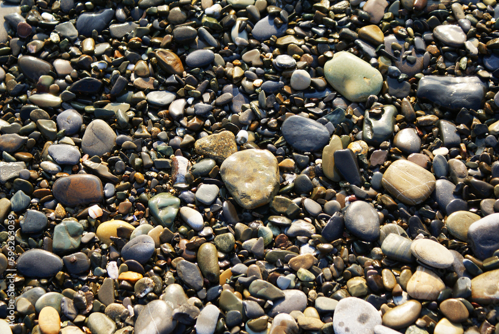 Stones on the seashore, pebbles on the beach, background. The sea coast. Stones on the seashore, pebbles on the beach, background. The sea coast.