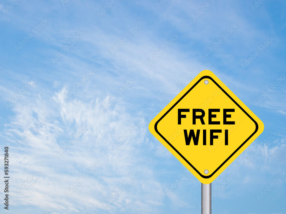 Yellow transportation sign with word free wifi on blue color sky background Yellow transportation sign with word free wifi on blue color sky background