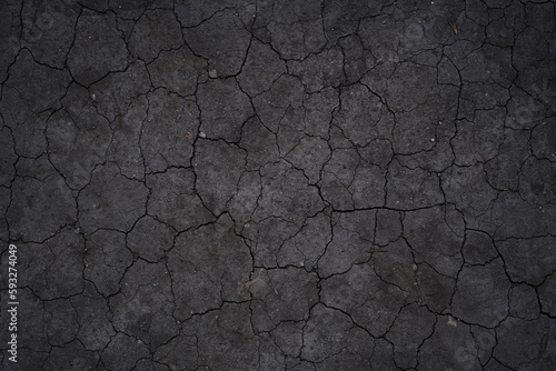 Dry cracked earth, cracks, earth in the sun, black earth, natural background with copy space. High quality photo