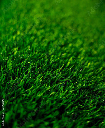 Background of artificial green grass at the showroom of a large store.