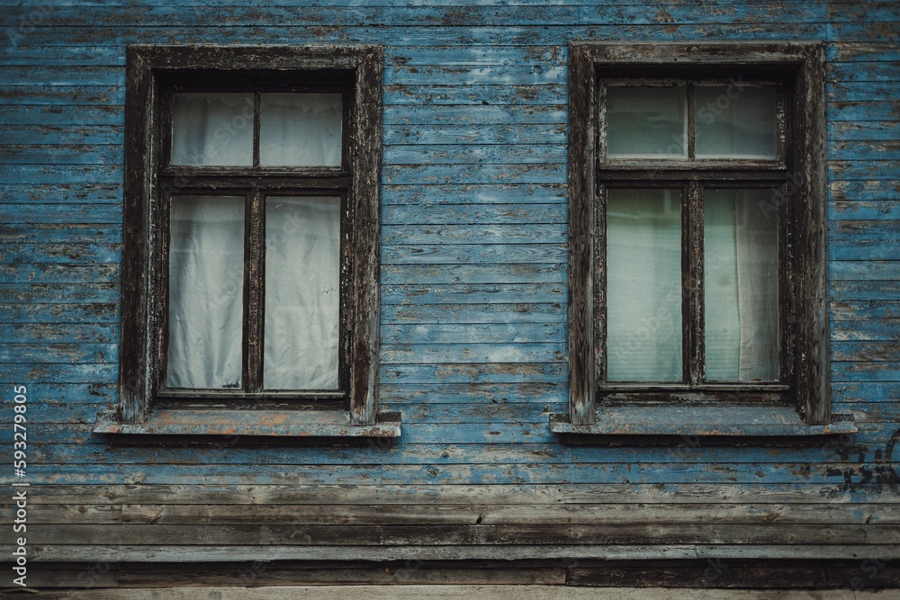 Old wooden house with closed glass windows