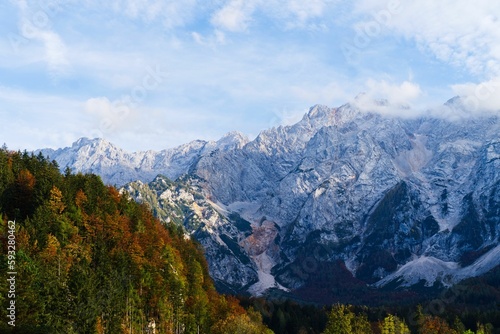 Landscape view of the Alps mountain range with autumn trees on the rocks