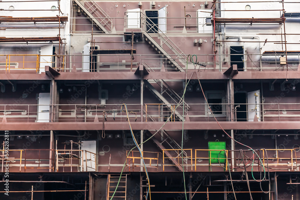 Construction of a new ship hull at the shipyard in Constanta, Romania. Part of the hull of the new ship with scaffolding. Construction of a new ship hull at the shipyard in Constanta, Romania. Part of the hull of the new ship with scaffolding.