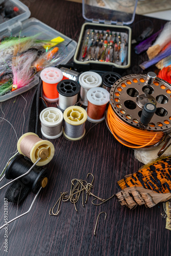 A set of various accessories and materials for tying flies for fly fishing. Close-up