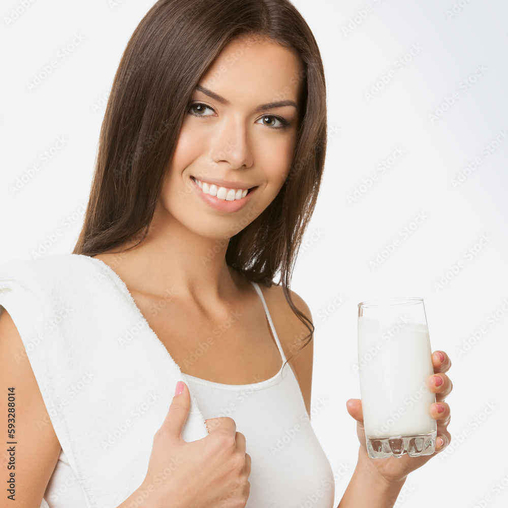 Square image - happy smiling young asian caucasian woman in white casual cloth wear with towel, isolated on light grey gray background. Brunette girl hold glass of milk at studio. Square image - happy smiling young asian caucasian woman in white casual cloth wear with towel, isolated on light grey gray background. Brunette girl hold glass of milk at studio.