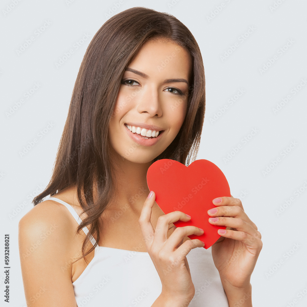 Square image - happy smiling asian caucasian woman in white casual cloth wear, isolated on light grey gray background. Brunette girl showing handmade heart paper symbol. Square image - happy smiling asian caucasian woman in white casual cloth wear, isolated on light grey gray background. Brunette girl showing handmade heart paper symbol.