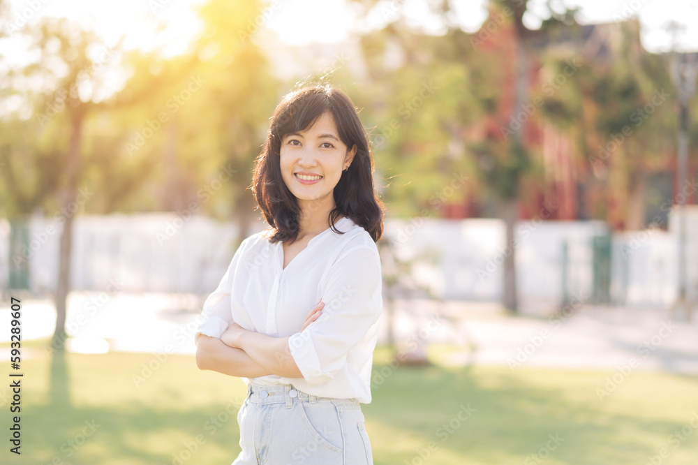 Portrait young beautiful asian woman with happy smile around outdoor park in sunny summer day Portrait young beautiful asian woman with happy smile around outdoor park in sunny summer day