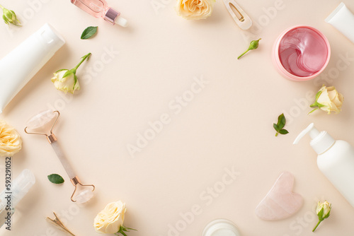 Elevate your skincare routine with this trendy concept featuring a flat lay top view of massage face rollers and cream bottles surrounded by stunning rose flowers on a pastel beige background