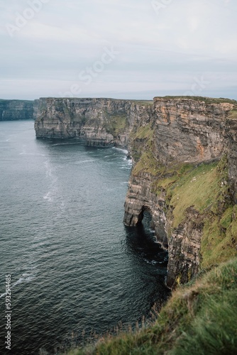 Beautiful vertical seascape with the rocky Cliffs of Moher at the shore, Ireland