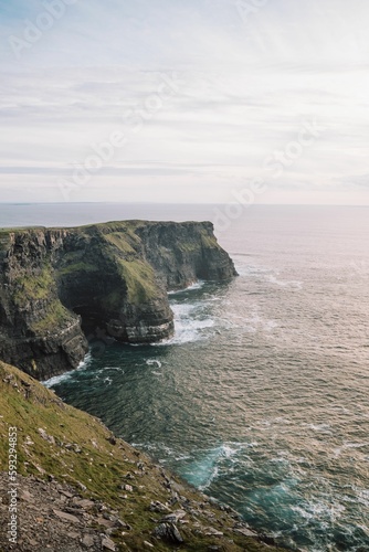 Beautiful vertical seascape with the rocky Cliffs of Moher at the shore, Ireland