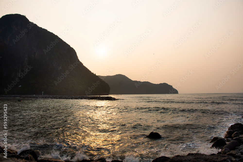 View landscape seascape and wave in sea ocean with island mountain while morning sunrise dawn time for thai people travelers travel visit rest relax at Khlong Wan city in Prachuap Khiri Khan, Thailand