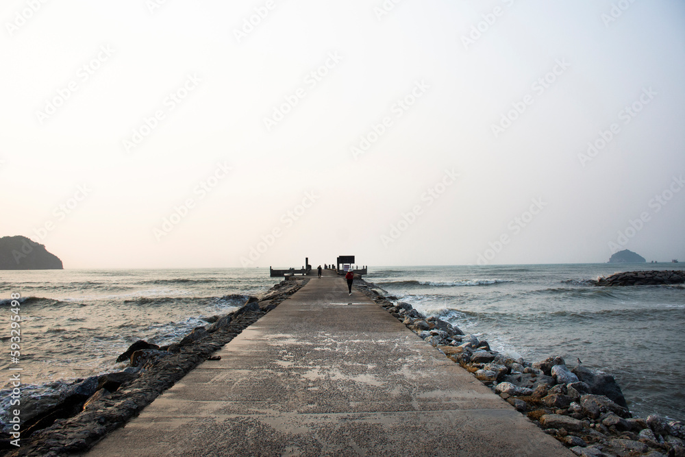 View landscape seascape and wave in sea ocean with concrete road jetty while morning sunrise dawn time for thai people travelers travel visit relax at Khlong Wan city in Prachuap Khiri Khan, Thailand