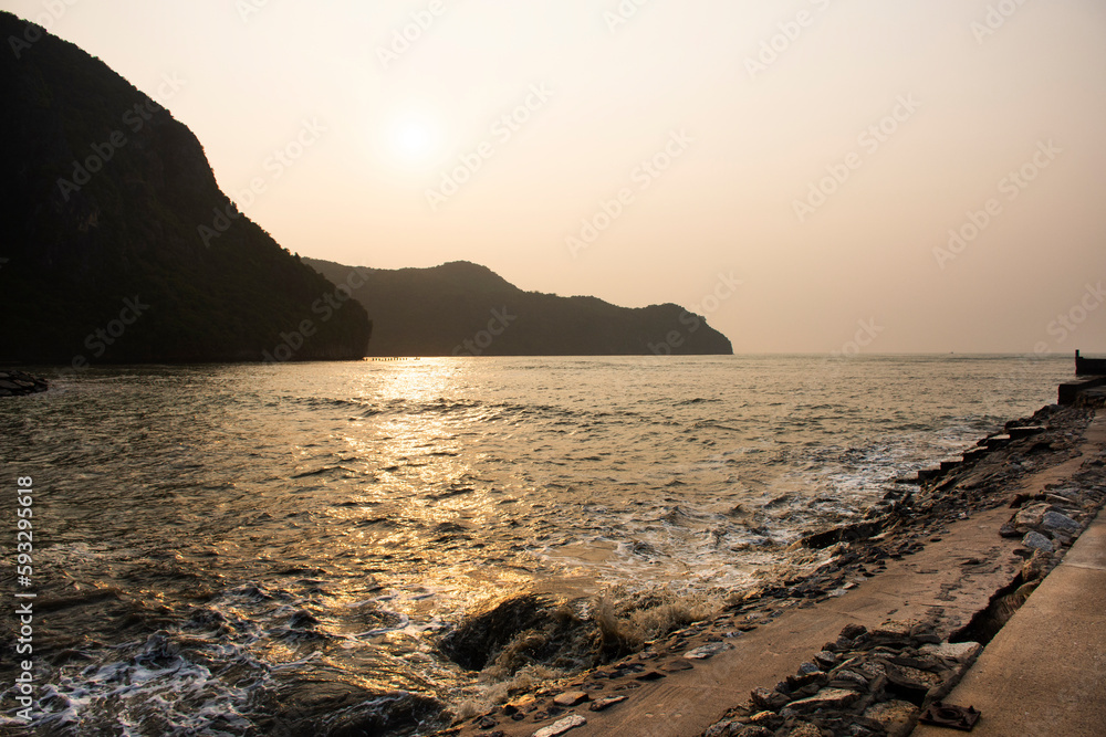 View landscape seascape and wave in sea ocean with island mountain while morning sunrise dawn time for thai people travelers travel visit rest relax at Khlong Wan city in Prachuap Khiri Khan, Thailand
