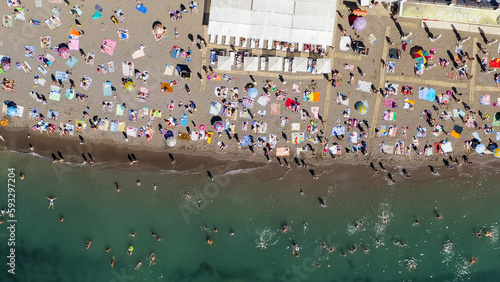 Sudak, Crimea - September 15, 2020: Embankment of Sudak. Black sea coast with beaches and people, Aerial View, HEAD OVER SHOT