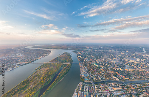 Astrakhan, Russia. Panorama of the city from the air in summer. The Volga River and Gorodstoy Island. Sunset time. Aerial view